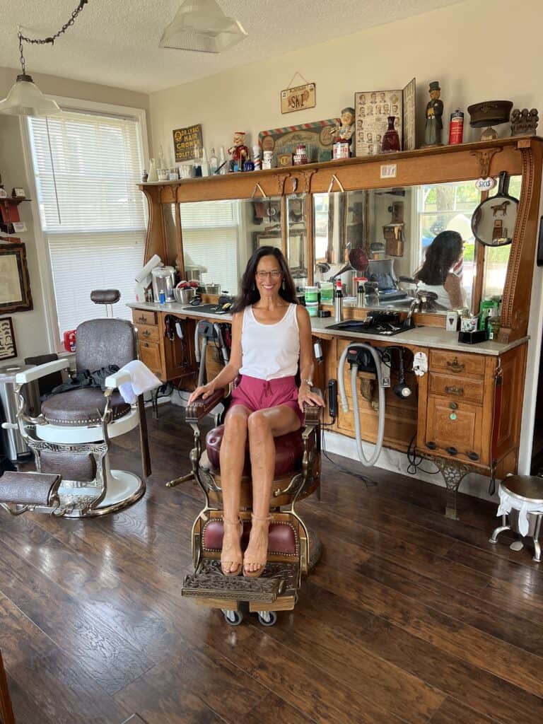 girl sitting in historic barbershop chair