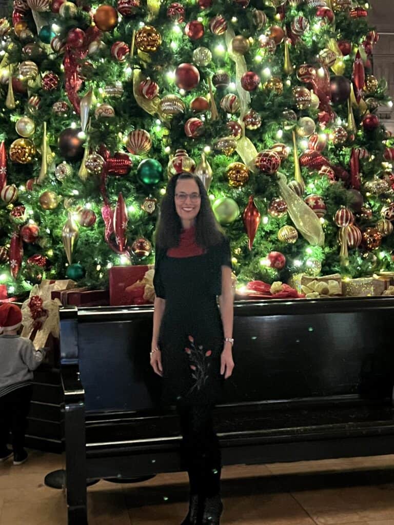 woman in front of Christmas tree in Union Station KC