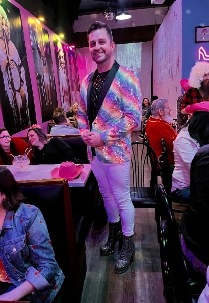 Man dressed in glitter jacket and boots